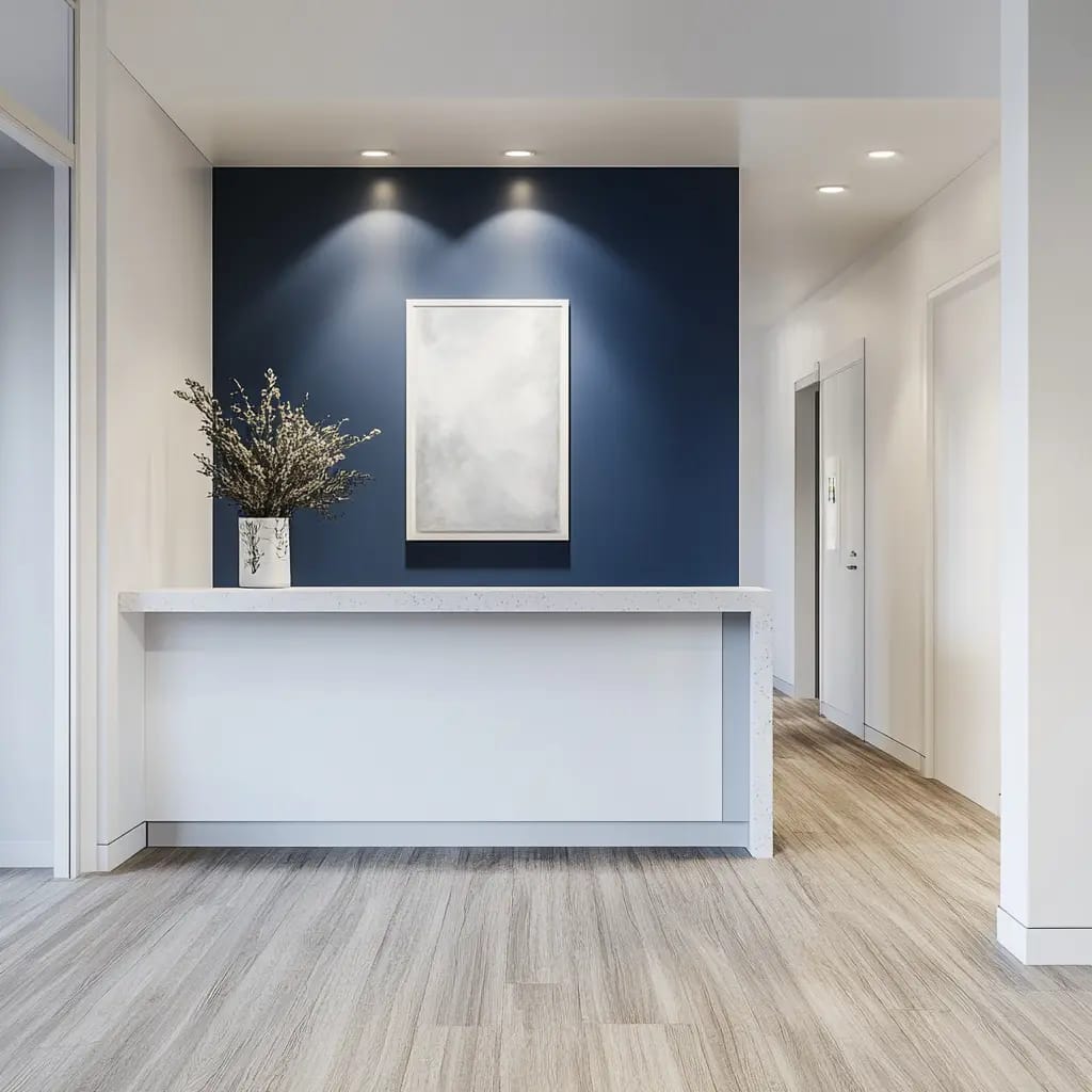 An all-white nurse station with inky blue accent paint in a skilled nursing facility.